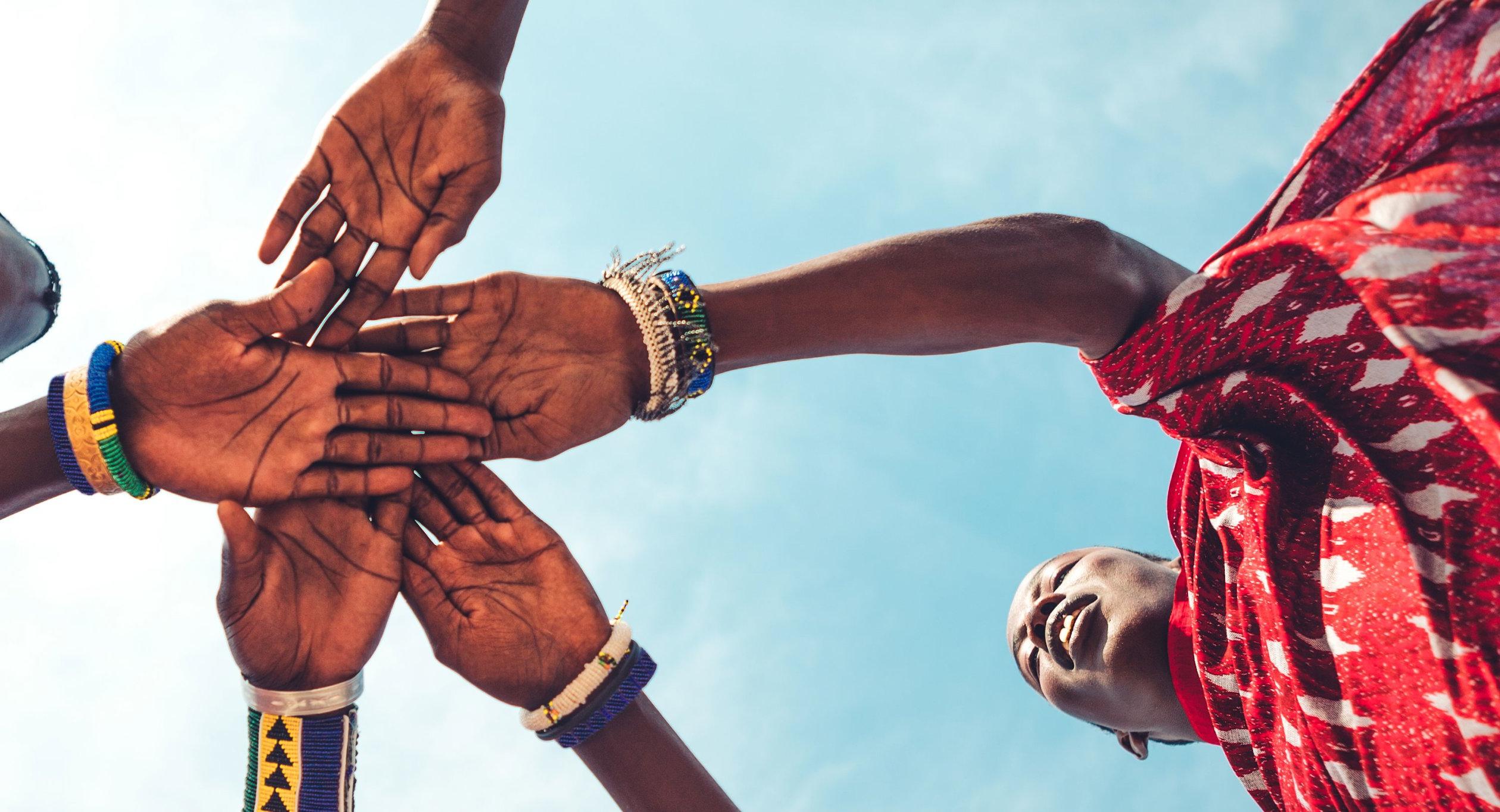 Shot from below of hands being held.