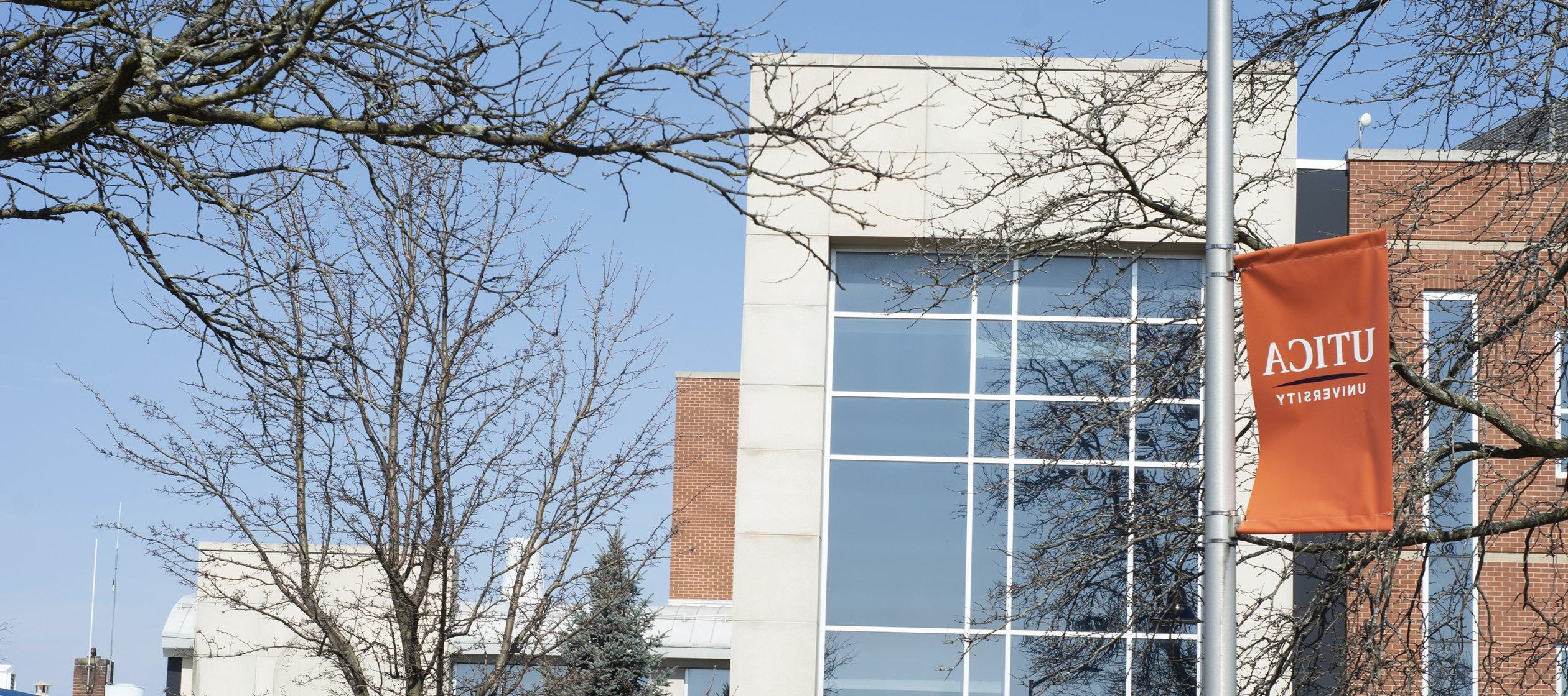 Orange University Banner outside Romano Hall.