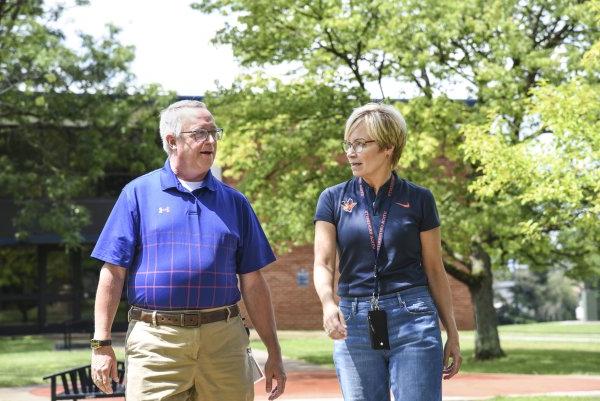 Laura Casamento and Todd Pfannestiel walk along the campus  in 2023