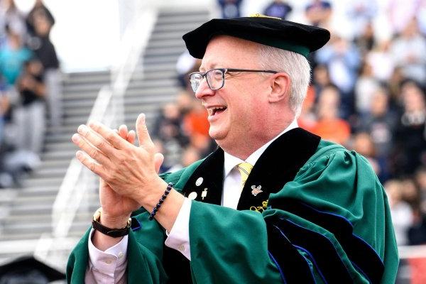 President Todd Pfannestiel clapping with the crowd at his Fall 2023 inauguration.